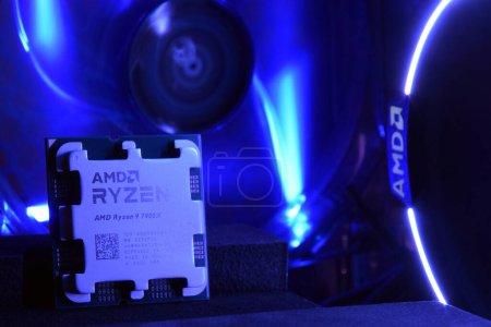 Photo for UKRAINE, KHARKIV, NOVEMBER 14, 2022: Close-up of an AMD Ryzen 9 7900X processor, against the backdrop of coolers with light. - Royalty Free Image
