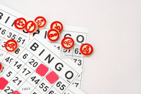 Foto de Muchas fichas de madera con números y tarjetas para un juego de mesa de bingo o lotería sobre un fondo claro. Lotto ruso tiene reglas similares al clásico juego de bingo mundial. - Imagen libre de derechos