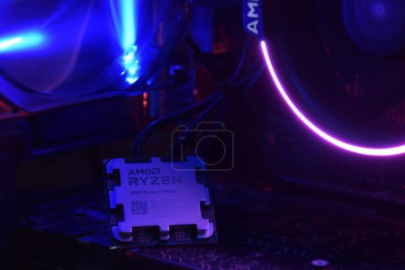 Photo for UKRAINE, KHARKIV, NOVEMBER 14, 2022: Close-up of an AMD Ryzen 9 7900X processor, against the backdrop of coolers with light. - Royalty Free Image