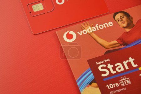 Photo for KHARKIV, UKRAINE - FEBRUARY 11, 2023: Vodafone starter pack on a red background. - Royalty Free Image