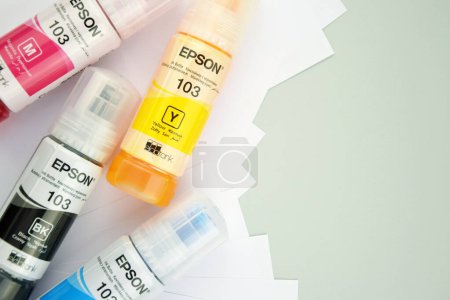 Photo for KHARKIV, UKRAINE - FEBRUARY 11, 2023: Four bottles of ink Epson, yellow, red, blue, black, built-in to the Epson L3150 series printer. - Royalty Free Image