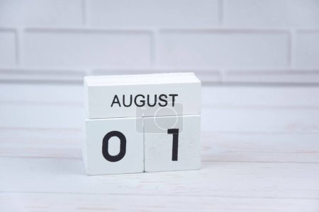 Photo for The white wooden perpetual calendar showing the 1st of August. - Royalty Free Image