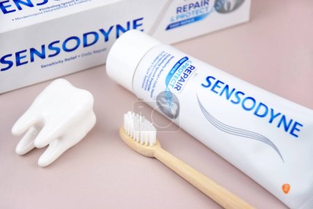 Photo for Kharkiv, Ukraine, AUGUST 19, 2023: A box of Sensodyne toothpaste on a light background. Sensodyne is a GlaxoSmithKline product. - Royalty Free Image