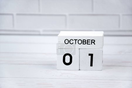 Photo for The white wooden perpetual calendar showing the 1st of October. - Royalty Free Image