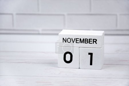 Photo for The white wooden perpetual calendar showing the 1st of November. - Royalty Free Image