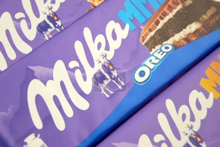 Photo for KHARKIV, UKRAINE - FEBRUARY 12, 2023: Chocolate brand Milka with Oreo flavor and caramel on a soft pink background. - Royalty Free Image