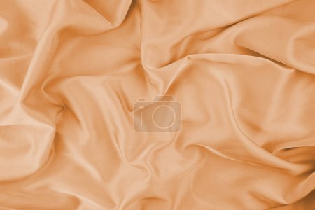 Orange chiffon fabric texture for background. Silk fabric. Selective focus.