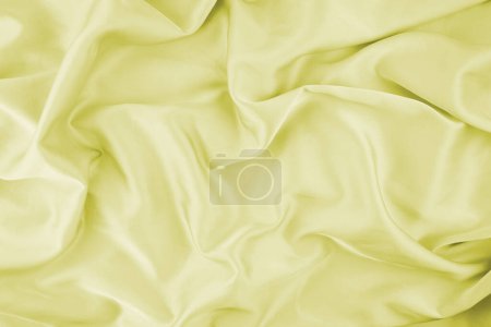 Yellow chiffon fabric texture for background. Silk fabric. Selective focus.