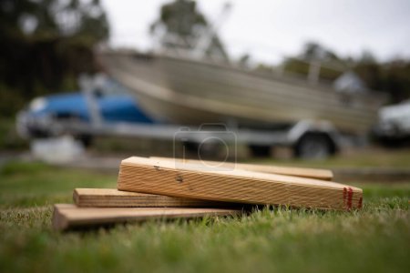 Photo for Wood chocks for a caravan and camping. chocks behind a tyre. camping chocks for a boat trailer of travellers in australia - Royalty Free Image