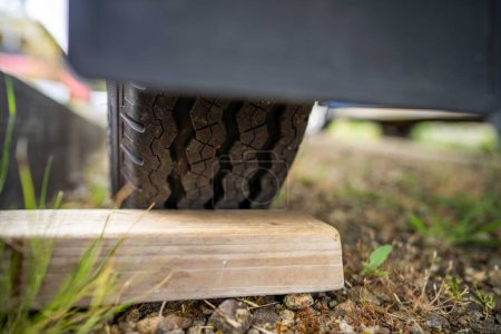 Photo for Tyre blocks for a trailer in a park for camping - Royalty Free Image