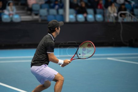 Photo for Tennis player playing on a court in a tennis tournament in summer in an arena - Royalty Free Image