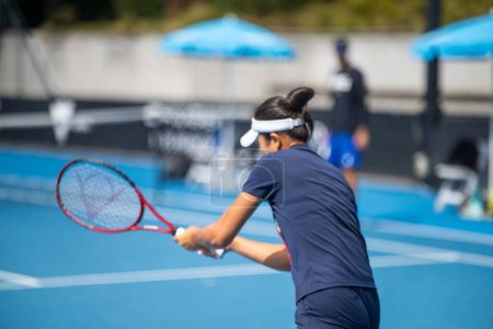Photo for Female Professional athlete Tennis player playing on a court in a tennis tournament in summe - Royalty Free Image