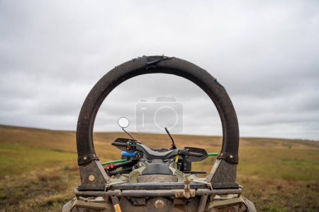Photo for Quad bike with a crush protection rollbar installed for safety in australia. australian motorbike in a field on a farm in australia - Royalty Free Image
