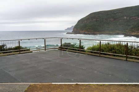 Photo for Ocean lookout looking out over waves and rocks in the rain - Royalty Free Image
