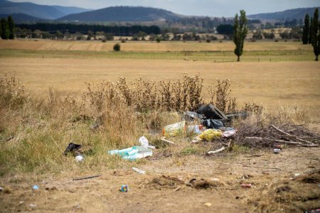 Photo for Rubbish dumped on the side of teh road in a park in nature - Royalty Free Image