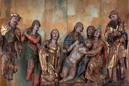Photo for Venzone, Italy - December 29, 2022: Medieval wooden group sculpture of the lamentation of the dead Christ by Giovanpietro da Mure preserved in the cathedral of Saint Andrew apostle in Venzone - Royalty Free Image