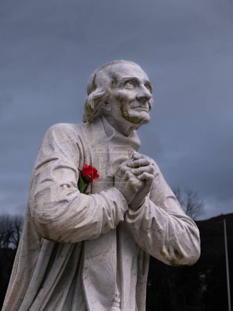 Photo for Lourdes, France - February 1, 2022: A statue of Jean-Marie Vianney , venerated as Saint John Vianney, a French Catholic priest and a patron saint of parish priests. - Royalty Free Image