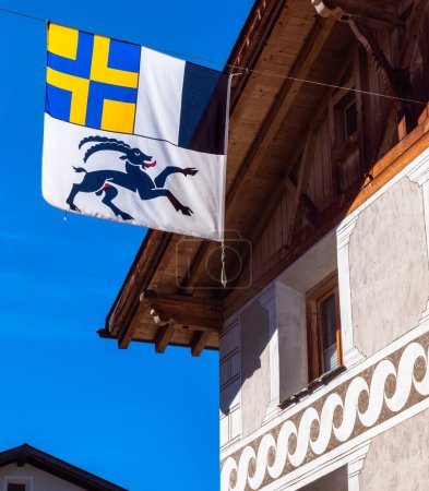 Photo for Traditional historical house in Mustair with the cantonal flag of the swiss canton of Graubunden - Grisons - Royalty Free Image