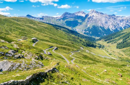 Photo for Landscape panoramic view of Splugen mountain pass in Switzerland and its alpine road with tight serpentines as well as the old road. - Royalty Free Image