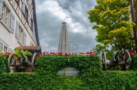 Photo for Arbon, Switzerland - July 23, 2023: Hotel, a guest house and restaurant Romerhof with two historical cannons. - Royalty Free Image