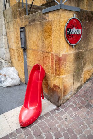 Photo for Neuchatel, Switzerland - August 7, 2023: A model of red fashion shoe on the street of Neuchatel - Royalty Free Image