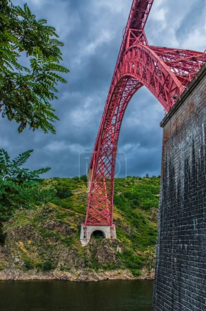 Photo for Garabit Viaduct, a red railway arch bridge constructed by Gustave Eiffel. Cantal, France - Royalty Free Image