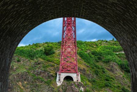 Photo for Garabit Viaduct, a red railway arch bridge constructed by Gustave Eiffel. Cantal, France - Royalty Free Image