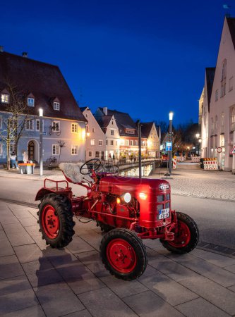 Photo for Memmingen, Germany - March 14, 2024: Vintage Fahr agricultural tractor on the street of Memmingen in the blue hour - Royalty Free Image