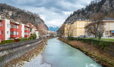 Feldkirch, Austria - March 15, 2024: Residential buildings left and the Vorarlberg State Conservatory right on the banks of river Ill