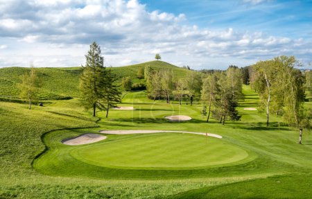 Golf and country club in Schonenberg, Hirzel, Switzerland. Drumlin hill with a lonely tree