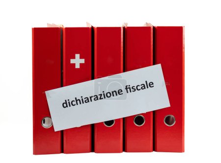 Concept for Swiss tax return. Office folders with Swiss flag symbol, and italian inscription in English translation: tax return