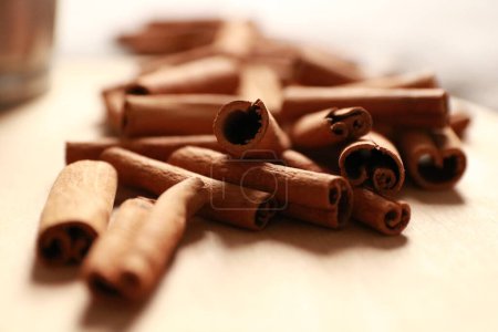 Photo for Sticks of cinnamon, blurred background - Royalty Free Image