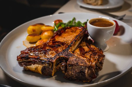 Photo for Beef with potatoes. Piece of t-bone steak in the plate with sauce. Delicious and tasty. - Royalty Free Image