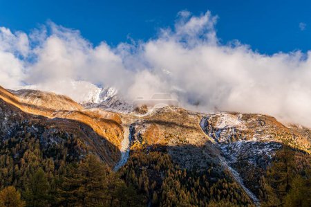 Photo for Landscape of the mountains, sky and forest in autumn. Snow covered mountain. Gouille, Evolene, Switzerland. - Royalty Free Image