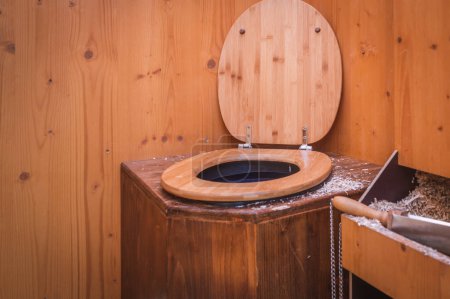 Photo for Wooden ecological composting toilet with sawdust - Royalty Free Image