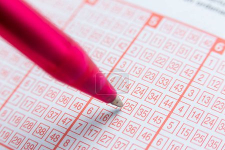 Photo for Detail of a lottery ticket. filling in a box marking a cross with a pen - Royalty Free Image