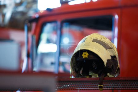A firefighter helmet placed on top of a truck, ready to go into action