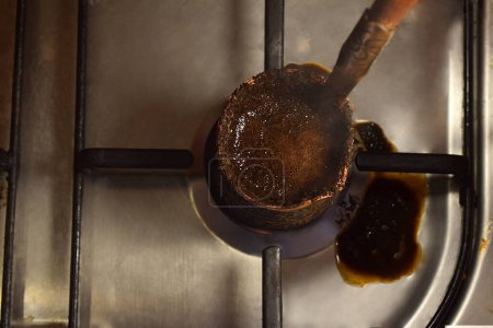 Photo for Coffee is brewed on a gas stove in a Turk. - Royalty Free Image