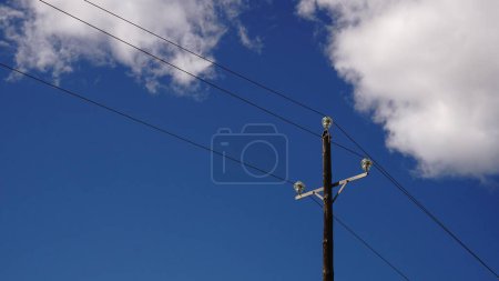 Photo for Wooden mast with electrical wiring against the sky - Royalty Free Image