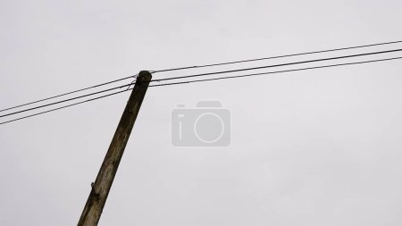 Photo for Wooden pole with wiring against the sky - Royalty Free Image