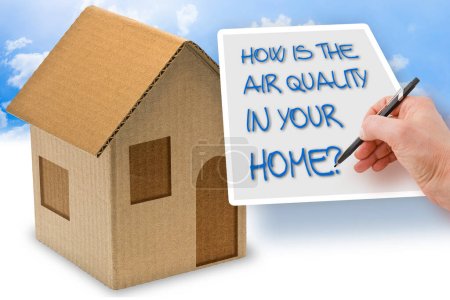 Foto de HOW IS THE AIR QUALITY IN YOUR HOME? - concept with a cardboard house - Imagen libre de derechos