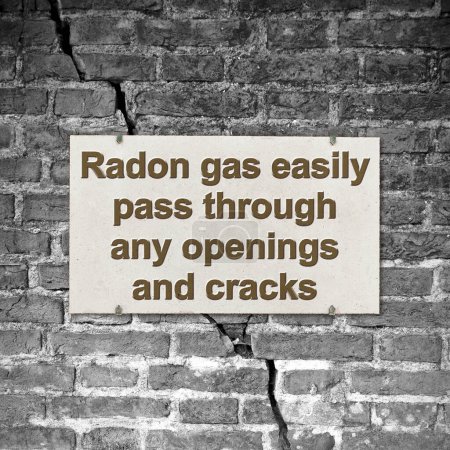 Foto de A cracked brick wall with warning message about radon gas escaping through cracks and openings - concept image - Imagen libre de derechos