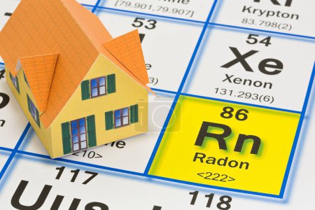 Foto de The danger of natural radon gas in our homes - concept with the Mendeleev periodic table of the elements and residential home model - Imagen libre de derechos