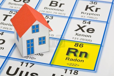 Photo for The danger of natural radon gas in our homes - concept with the Mendeleev periodic table of the elements and residential home model - Royalty Free Image