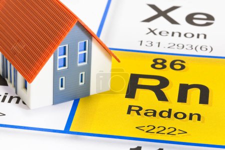 Photo for The danger of natural radon gas in our homes - concept with the Mendeleev periodic table of the elements and residential home model - Royalty Free Image