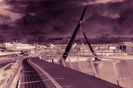Photo for Urban skyline of Derry city (also called Londonderry) in northern Ireland with the famous "Peace Bridge" (Europe - Northern Ireland) - Art Toned image - Royalty Free Image