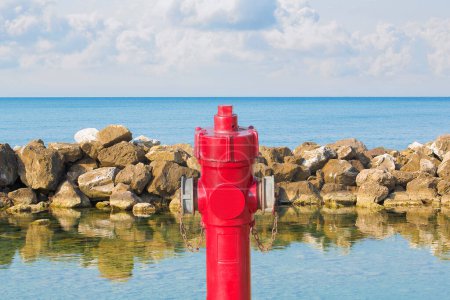 Photo for An improbable hydrant at the seaside - Plenty of water concept image - Royalty Free Image