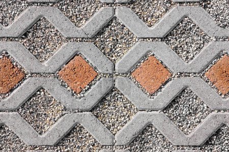 Photo for Concrete self locking tiled and draining flooring blocks assembled on a substrate of sand with gravel - type of flooring permeable to rain water as required by laws used in car parking areas - Royalty Free Image