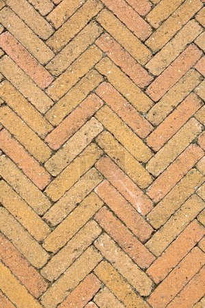 Photo for Concrete self locking flooring blocks for outdoor use assembled on a substrate of sand - type of flooring permeable to rain water as required by the building laws called a herringbone pattern due to its particular shape - Royalty Free Image