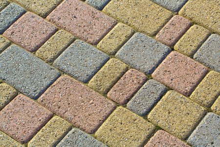 Photo for Colored concrete self locking flooring blocks assembled on a substrate of sand - type of flooring permeable to rain water as required by the building laws - Royalty Free Image